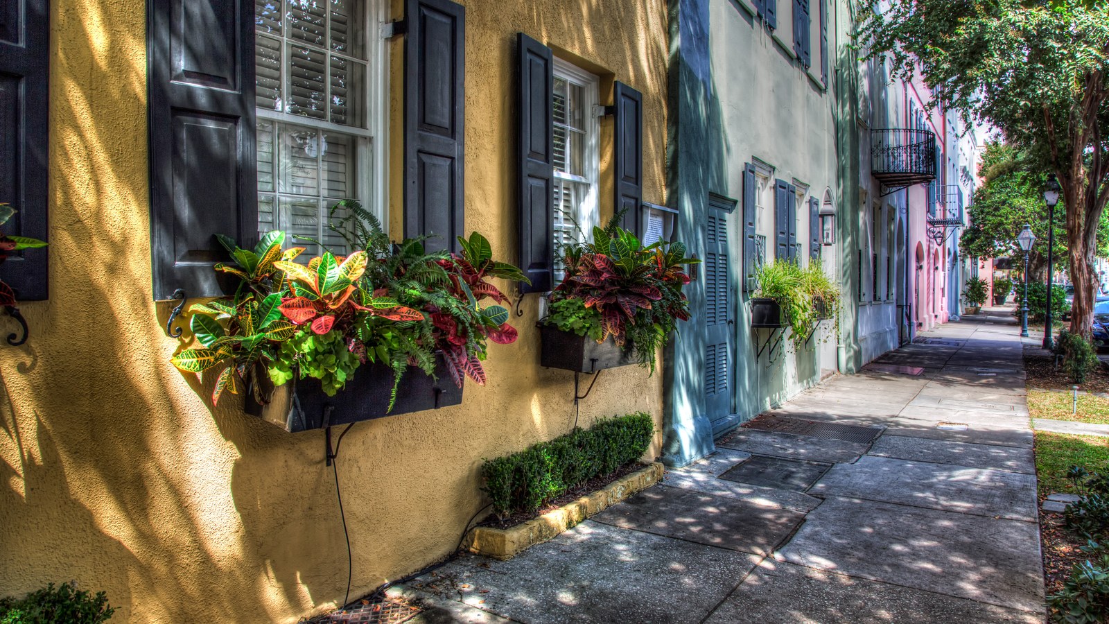 Colorful historic houses with window flower boxes along Rainbow Row on East Bay Street in downtown Charleston