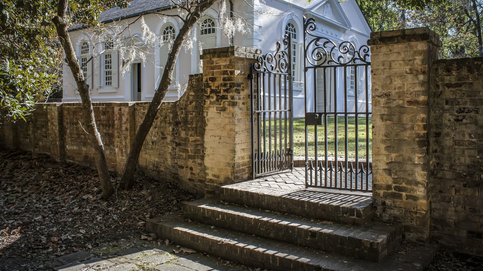 The brick wall and iron gate at St. James Goose Creek Parish Church, a colonial-era church built around 1719