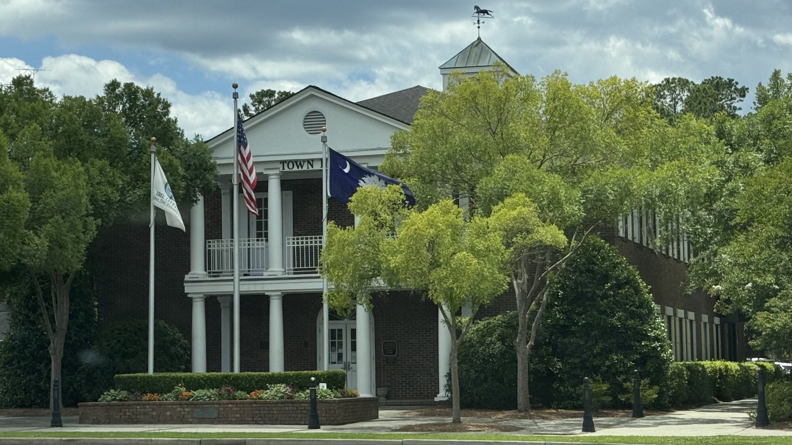 Summerville's Town Hall, a two-story brick building with white columns and a cupola