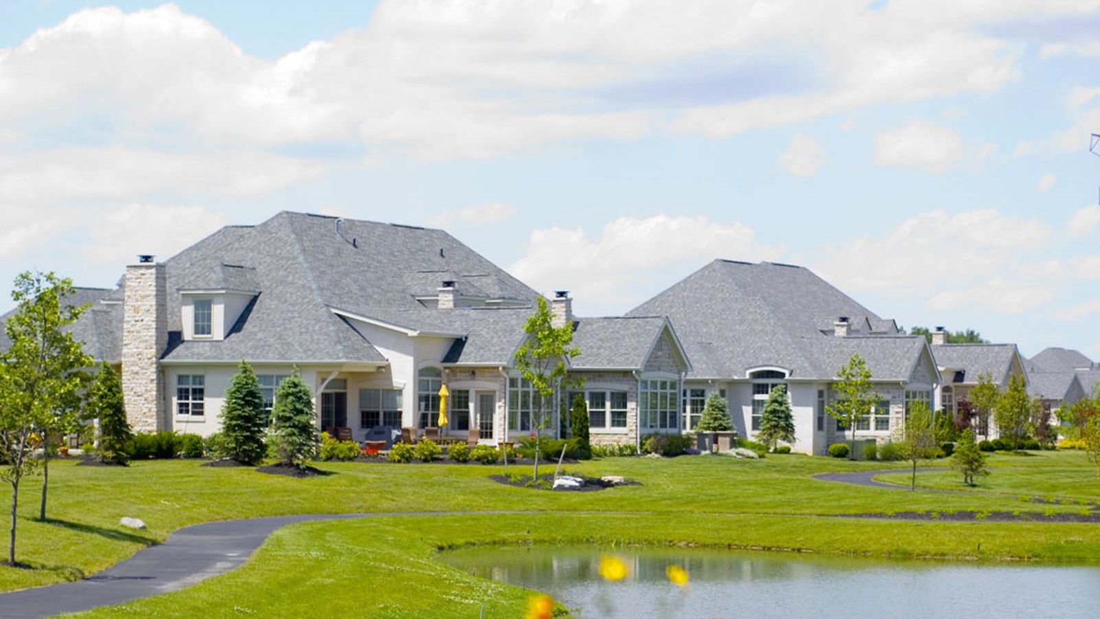 Houses backing onto a landscaped pond in a Powell, Ohio subdivision near Rutherford Road and Sawmill Parkway