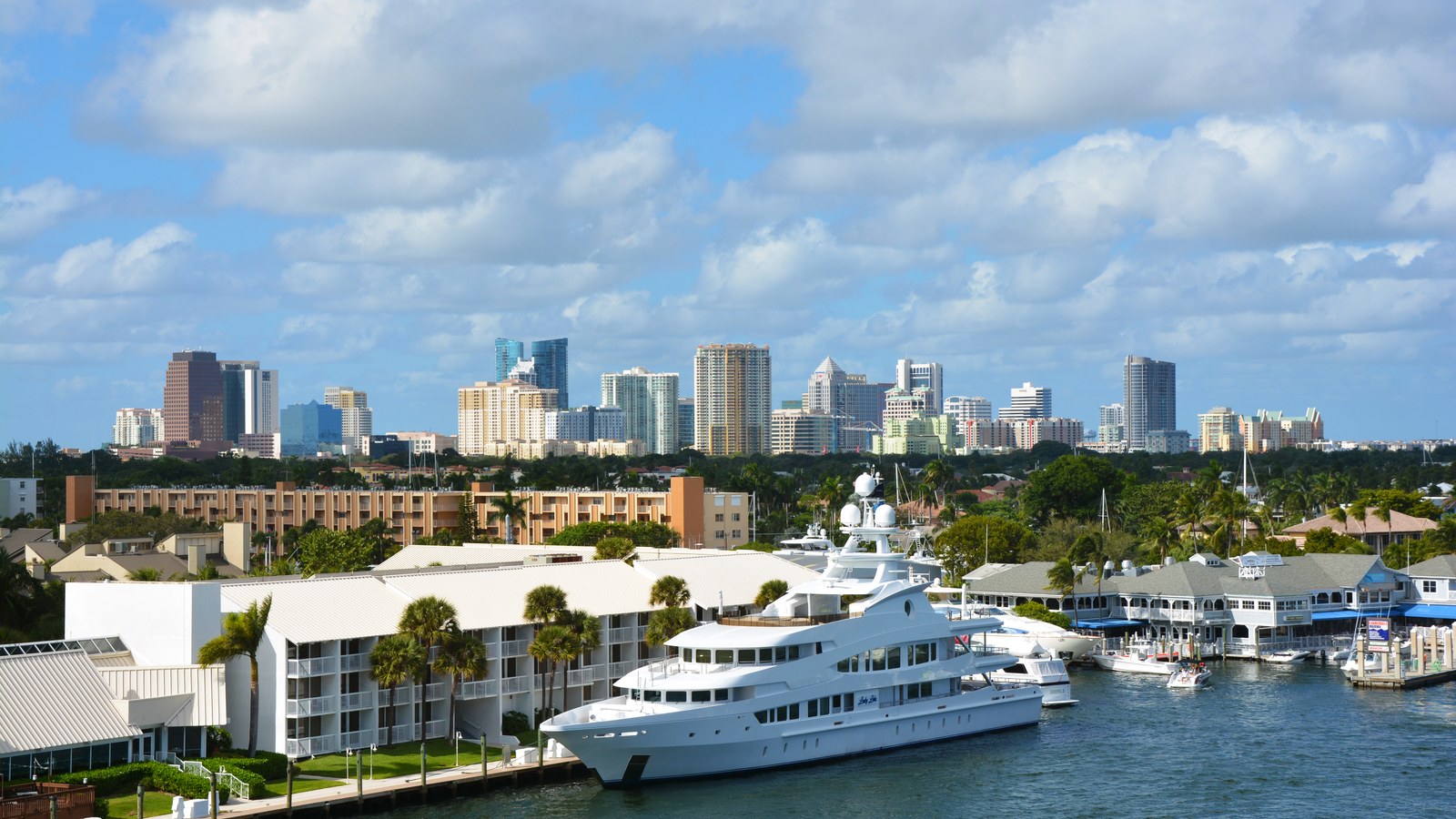 Downtown Fort Lauderdale's skyline seen across the New River, with a yacht docked in the foreground