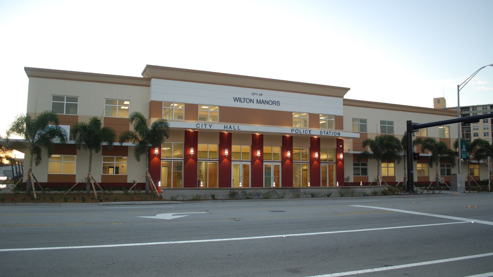 The City of Wilton Manors' combined City Hall and Police Station building on Wilton Drive, lit at dusk