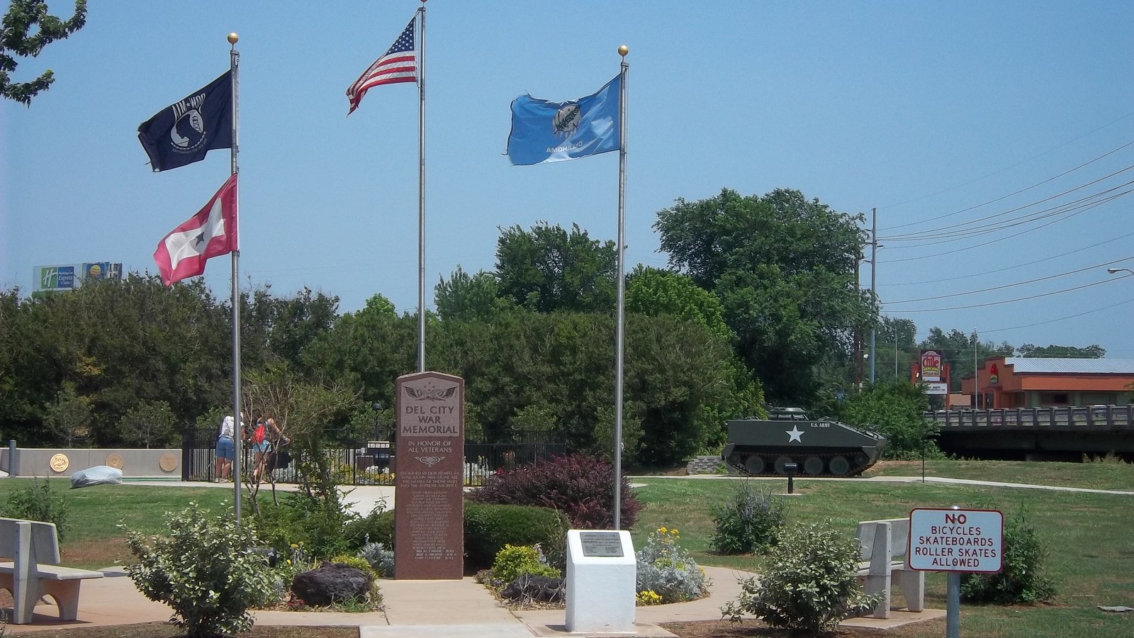 The Del City War Memorial, with flags and a display of military armor, at a park in Del City, Oklahoma
