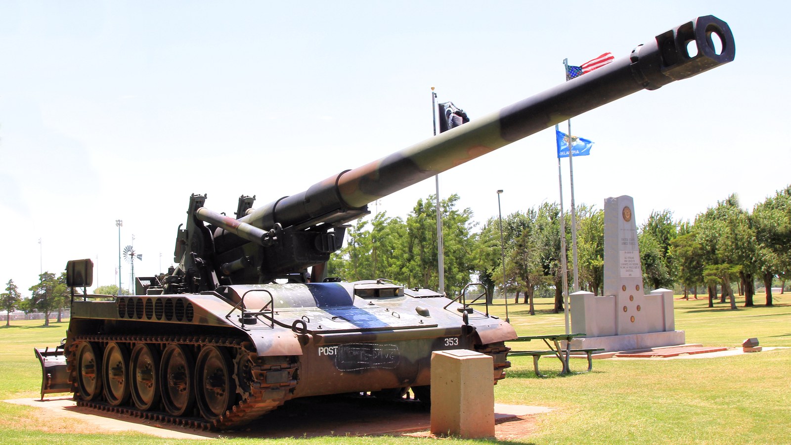 A memorial howitzer and veterans monument on display at a park in Mustang, Oklahoma