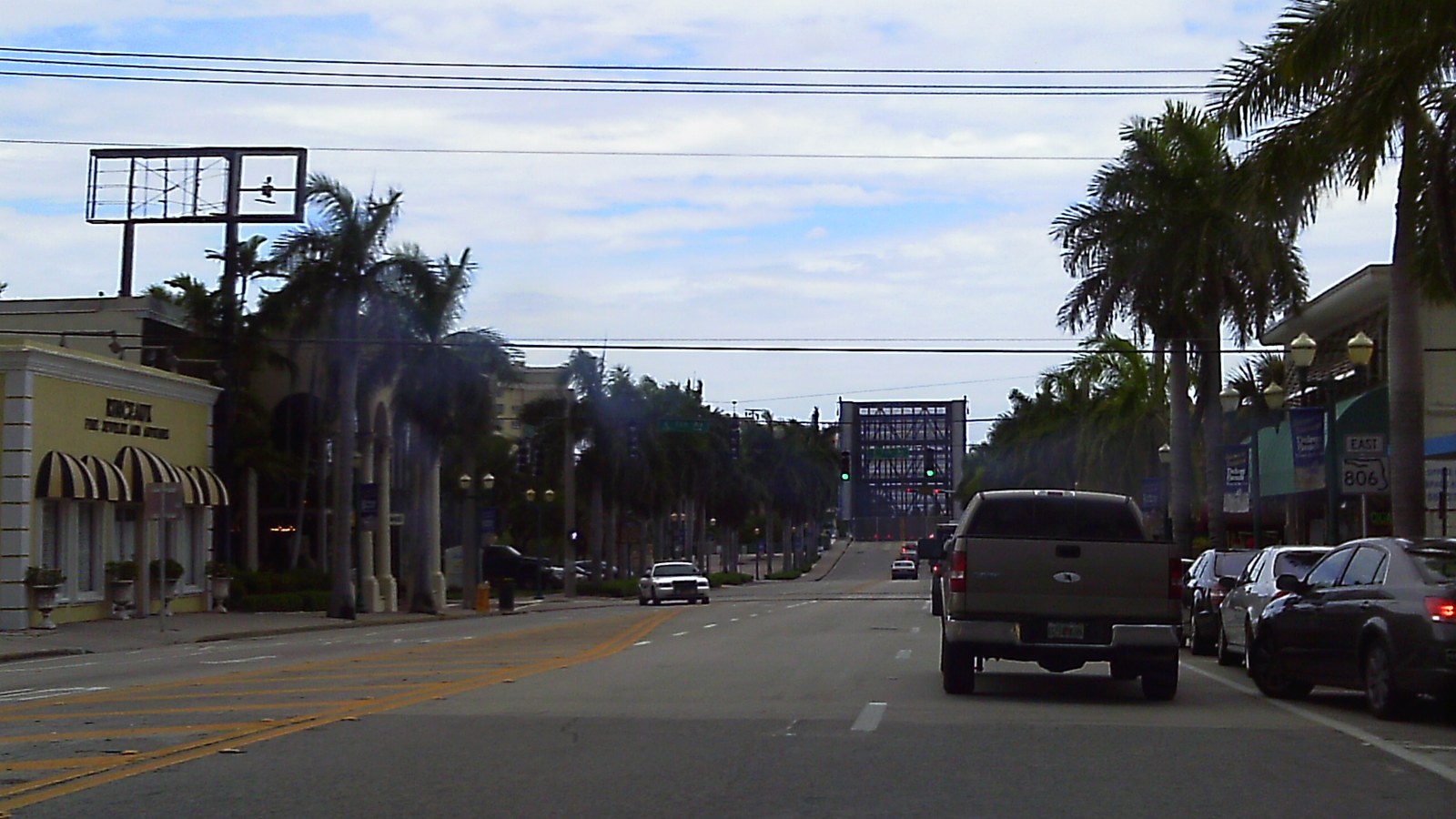 Atlantic Avenue's palm-lined downtown corridor in Delray Beach, looking east toward the Intracoastal drawbridge