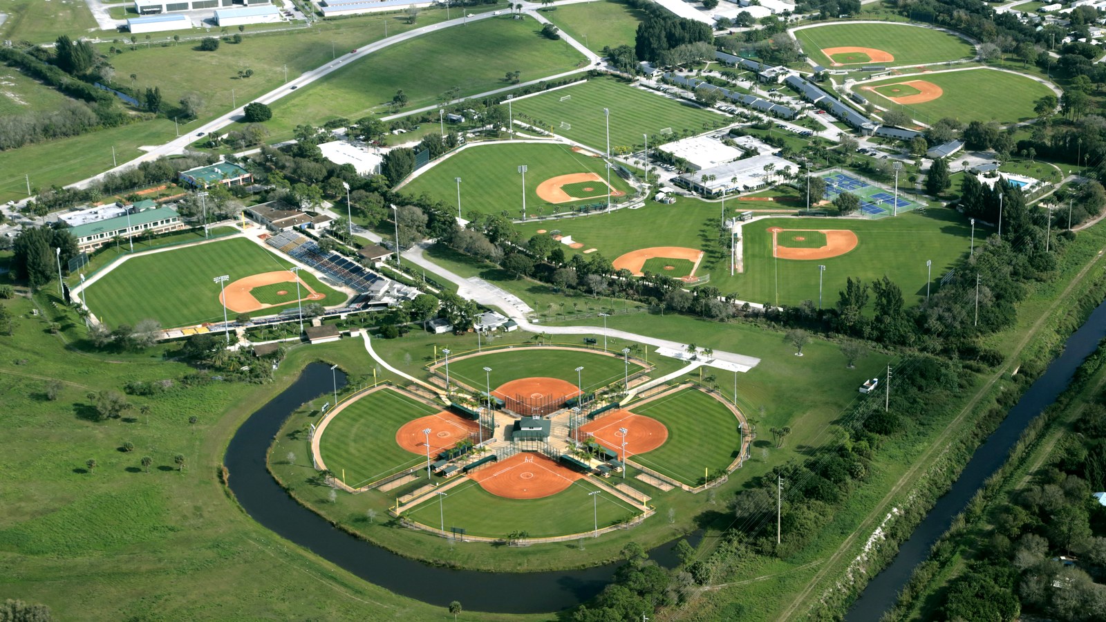 An aerial view of Historic Dodgertown/the Jackie Robinson Training Complex in Vero Beach, showing Holman Stadium's distinctive four-diamond clover-shaped baseball and softball field layout