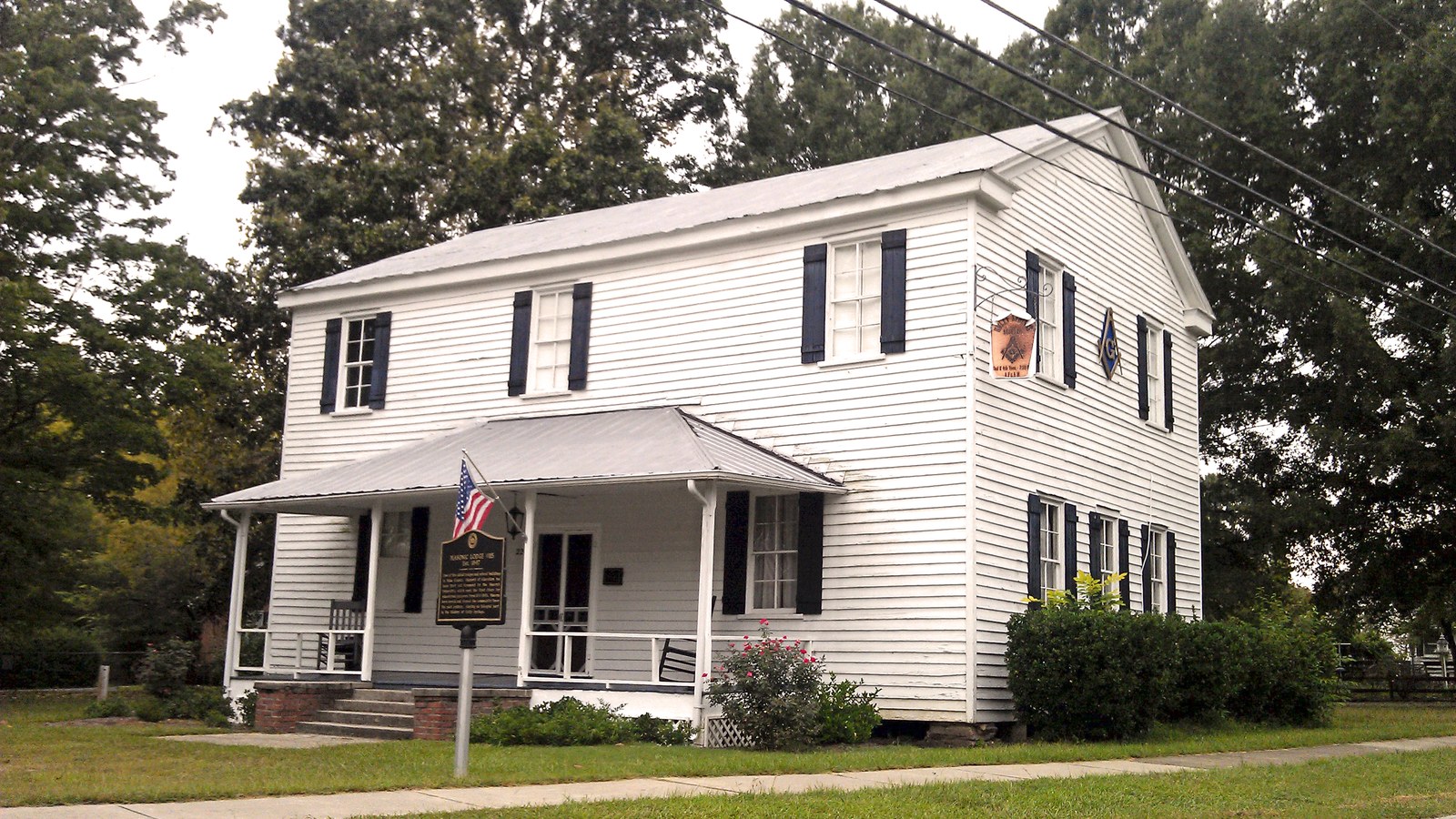 Holly Springs Masonic Lodge, a white two-story historic building listed on the National Register of Historic Places