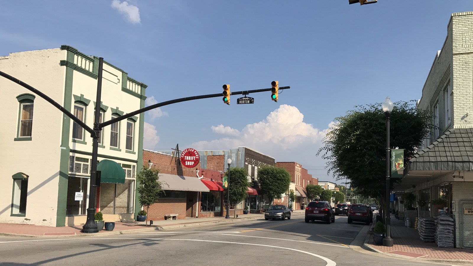 Downtown Zebulon street intersection with a two-story brick building, traffic signals, and small-town storefronts