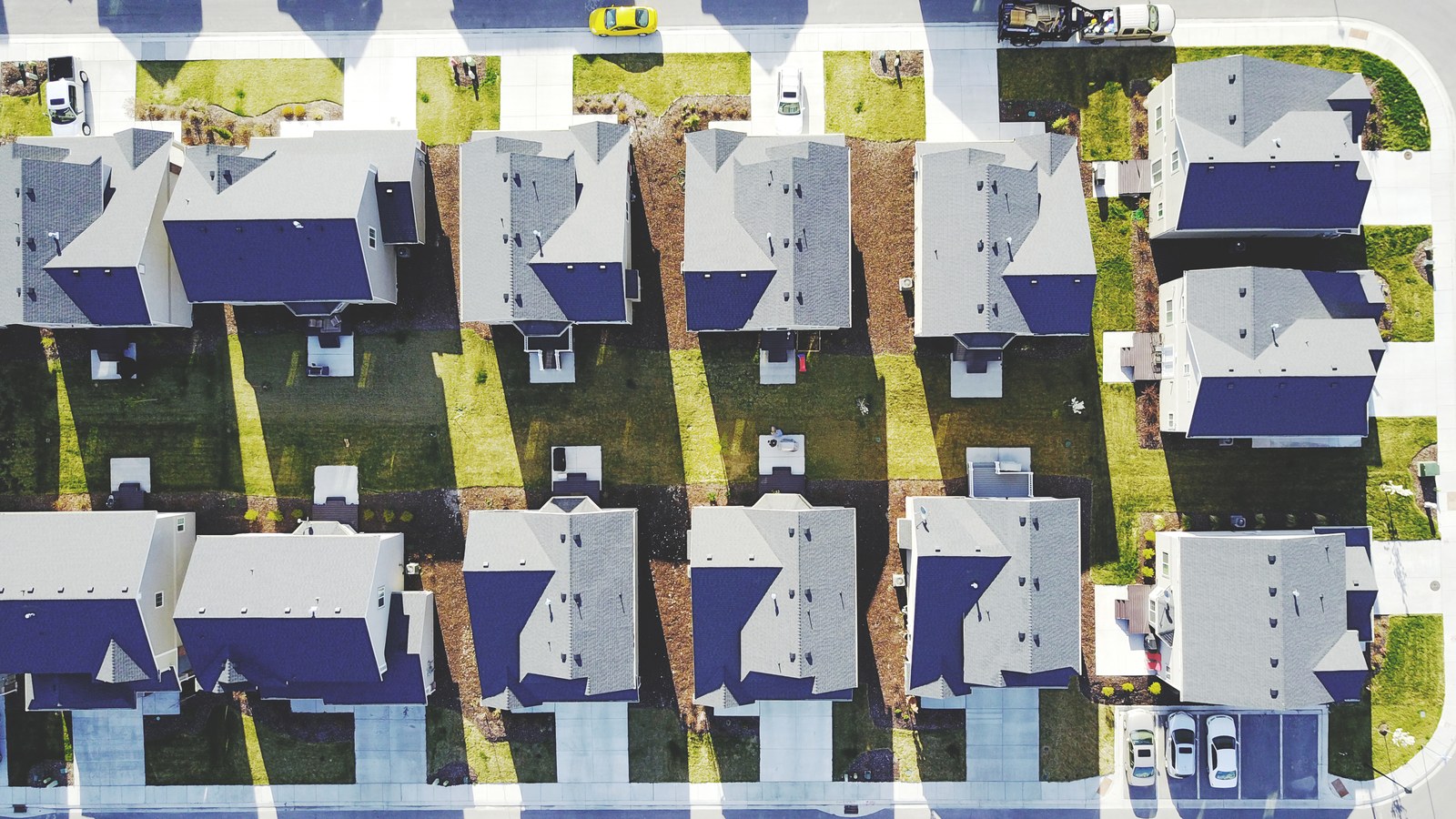 Aerial view straight down on a row of similar new houses, driveways, and yards in an American Fork, Utah subdivision