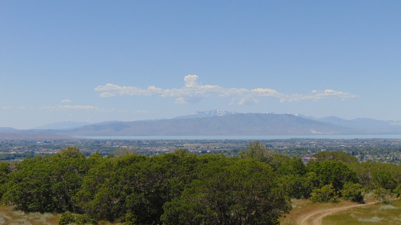 A hazy view across Spanish Fork and Utah Lake toward the Lake Mountains and Oquirrh Mountains, seen from the Spanish Oaks Reservoir overlook