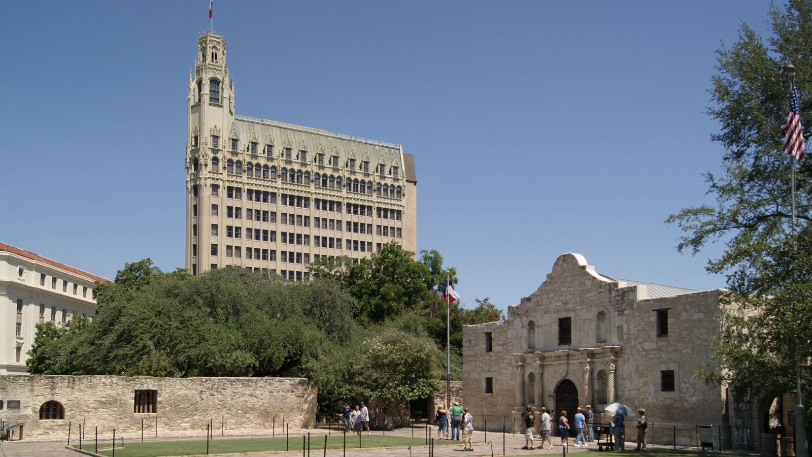 The Alamo's facade with the Emily Morgan Hotel's Gothic tower rising behind it in downtown San Antonio